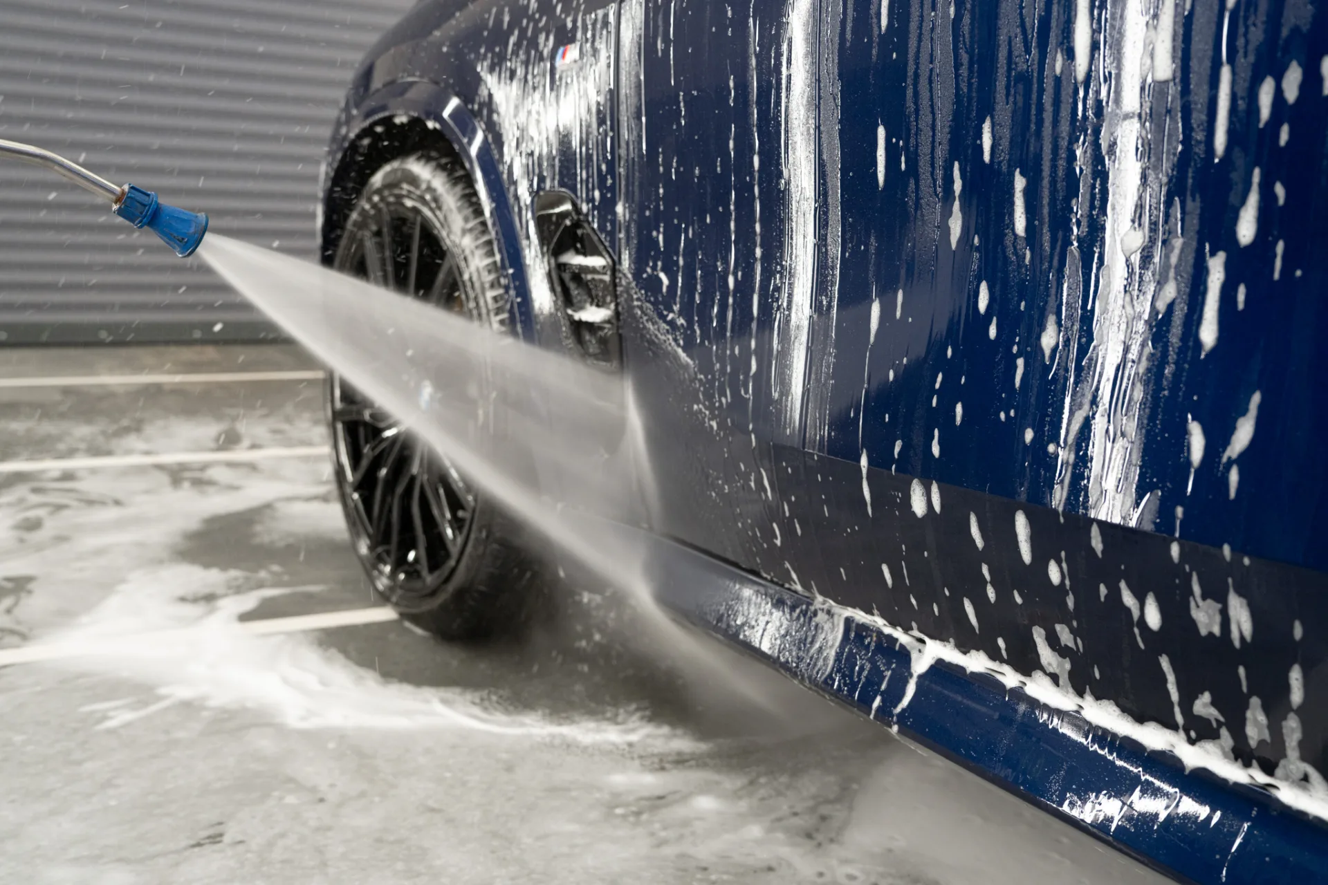 Pressure-washer rinse β softened dirt rolling off the bodywork